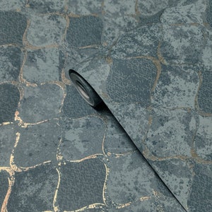 May include: A roll of blue and gold wallpaper with a geometric pattern. The wallpaper has a textured, distressed look.
