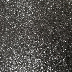 May include: A close-up of a black sparkly surface with a fine-grained texture.