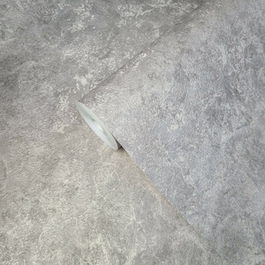 May include: A roll of gray textured wallpaper with a subtle white marbling effect.