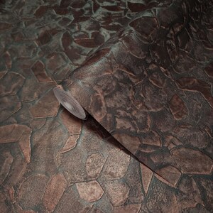May include: A roll of brown and green textured wallpaper with a stone-like pattern. The wallpaper has a metallic sheen.