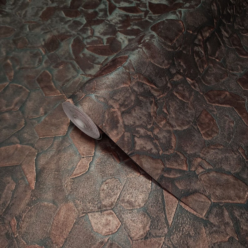 May include: A roll of brown and green textured wallpaper with a stone-like pattern. The wallpaper has a metallic sheen.