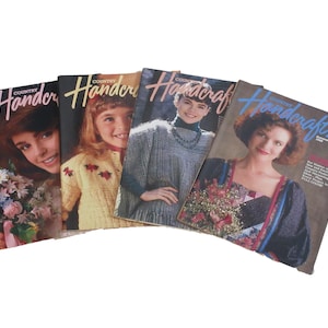May include: A collection of five vintage "Country Handcrafts" magazines. Each cover features a different person, with the magazine titles in a cursive font. The covers display various colors and designs, showcasing the craft theme.