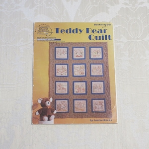 May include: A vintage booklet titled "Teddy Bear Quilt" by Louise Kocka. The booklet is from the American School of Needlework and features iron-on transfers for a quilt design with 16 teddy bear motifs.
