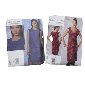 May include: Two Anne Klein sewing pattern envelopes. One shows a blue dress, the other a red and black patterned dress. The envelopes feature images of the dresses and the Anne Klein logo.