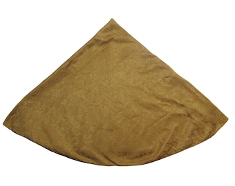 May include: A golden-brown, triangular fabric item with a subtle floral pattern. The fabric is folded, creating a three-dimensional shape. The item appears to be a decorative textile.