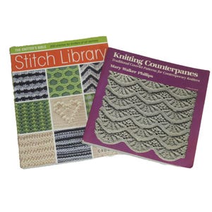 May include: Two books on a white background. The book on the left is titled "Stitch Library" with a colorful cover showing various stitch patterns. The book on the right is titled "Knitting Counterpanes" with a purple cover.