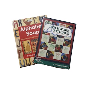 May include: Two books on a white background. The book on the left is titled "Alphabet Soup" with a red background and colorful letters. The book on the right is titled "Patchwork Stitches" with a patchwork design on the cover.