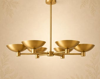 May include: A gold-toned metal chandelier featuring a central vertical rod connected to six horizontal arms, each supporting a wide, shallow, bowl-shaped light fixture. The design is symmetrical with a smooth, matte finish throughout the structure.