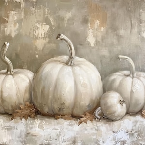 May include: Three white pumpkins with a textured, painted surface, arranged on a white background with brown leaves.