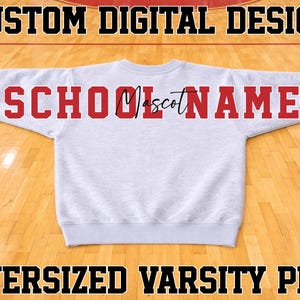 May include: A light grey crewneck sweatshirt featuring the red text SCHOOL NAME with the word Mascot in black cursive script across the centre. The top of the image displays CUSTOM DIGITAL DESIGN and the bottom displays OVERSIZED VARSITY PNG.