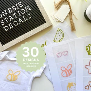 May include: A collection of 30 decal designs, tags, and posters. The image features a white onesie with a yellow bee decal, a letter board with the text "ONESIE STATION DECALS", and various sticker designs including a watermelon slice and sunglasses.