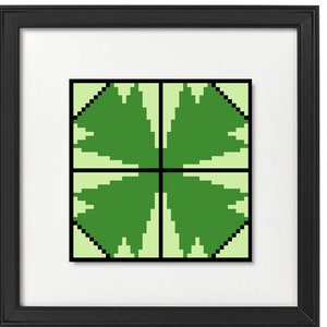 May include: A framed print featuring a pixelated four-leaf clover design. The artwork is composed of shades of green and black, set against a light green background. The print is encased in a black frame with a white mat.