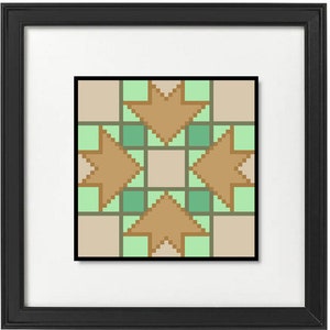 May include: A framed artwork featuring a geometric design. The artwork has a black frame and a white mat. The design is composed of tan, green, and beige pixelated shapes, including star-like and square elements. The overall aesthetic is modern and minimalist.