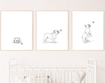 May include: Three black and white illustrations of French Bulldogs in a nursery setting. The first illustration shows a bulldog lying down, the second shows a bulldog standing and looking up, and the third shows a bulldog standing on its hind legs.