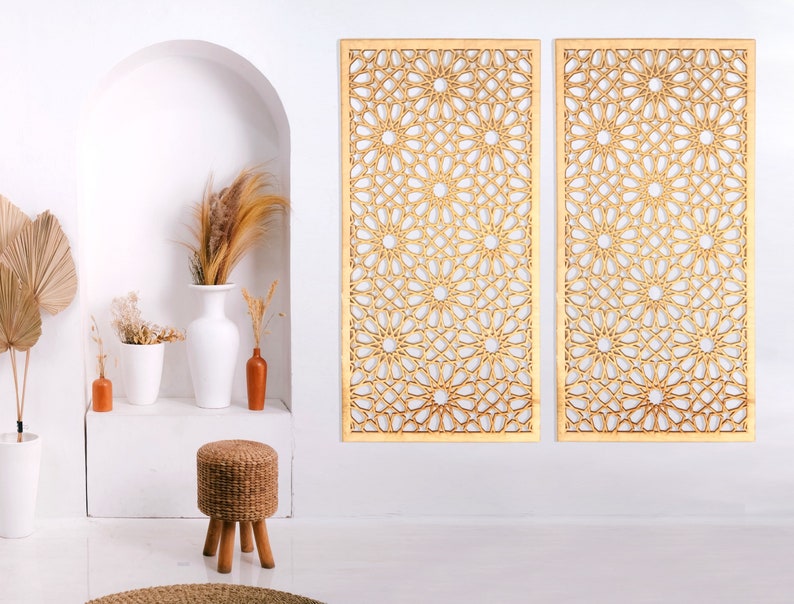 May include: Two wooden wall panels featuring a geometric design of interlacing circles and stars. The panels are light brown and have a natural wood finish.