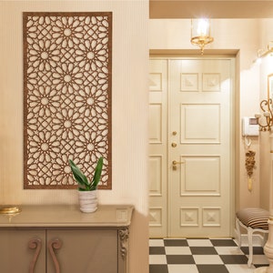 May include: A hallway with a white door, a decorative wooden wall panel, a small table with a plant, and a black and white chequered floor.
