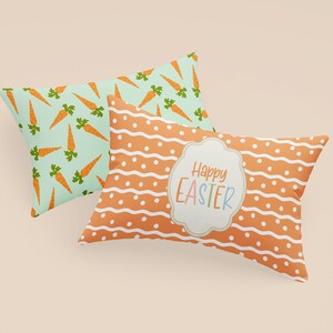 K&ouml;nnte beinhalten: Zwei dekorative Kissen mit Ostern-Motiven. Ein Kissen hat einen hellblauen Hintergrund mit orangenen Karotten, das andere Kissen einen orangenen Hintergrund mit wei&szlig;en Punkten und Wellenlinien. Das zweite Kissen hat ein wei&szlig;es Etikett mit dem Text "Frohe Ostern" in bunten Buchstaben.
