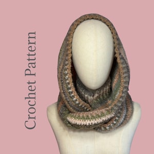 May include: A handmade crochet cowl in shades of brown, green, and pink, displayed on a mannequin head. The cowl features a textured stitch pattern and is designed to be worn around the neck. The words "Crochet Pattern" are printed on the left side.