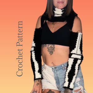 May include: Black and white striped crochet arm warmers and a matching neck warmer. The arm warmers are worn on the arms of a person wearing a black crop top and denim shorts. The text "@thecreativintematrixx" is visible in the image.