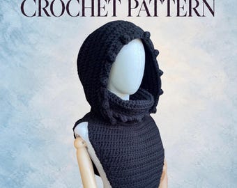 May include: A black crochet hood with a textured bobble trim along the edge, worn on a mannequin. The text DIGITAL PDF CROCHET PATTERN is displayed above the hood. The hood features a thick, ribbed neck section and a pointed front panel.