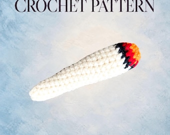 May include: A digital PDF crochet pattern featuring a text header that reads DIGITAL PDF CROCHET PATTERN. Below the text is a crocheted object shaped like a cone, primarily white with a black band near the tip, followed by red and orange yarn.