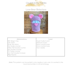 May include: A pink crocheted balaclava with heart-shaped ears. The balaclava is designed to cover the head and neck, with a hole for the face. The pattern includes instructions for crocheting the balaclava using US terminology.