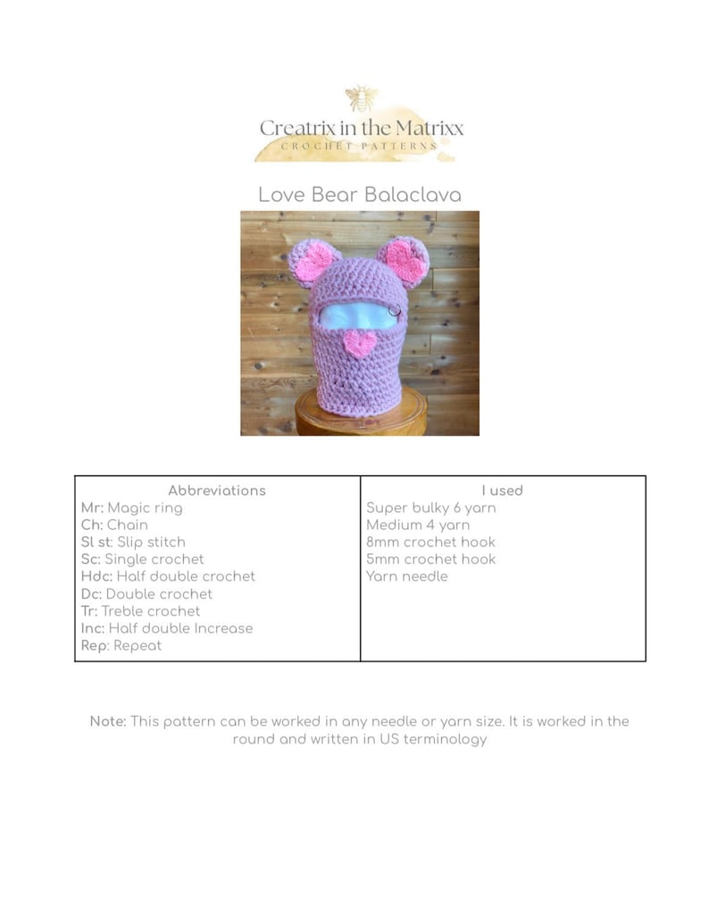 May include: A pink crocheted balaclava with heart-shaped ears. The balaclava is designed to cover the head and neck, with a hole for the face. The pattern includes instructions for crocheting the balaclava using US terminology.