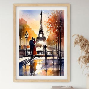 May include: Watercolour painting of the Eiffel Tower in Paris, with a couple embracing on a bridge. The artwork features warm colours, including orange, yellow, and blue, with reflections in the water. The painting is framed in a light wood frame.