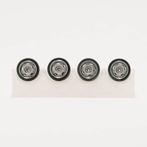 May include: Four small, circular toy car wheels with black rubber tires and five-spoke silver rims. The wheels are arranged in a horizontal row and are held in place by a translucent, white, wavy-edged plastic display stand.