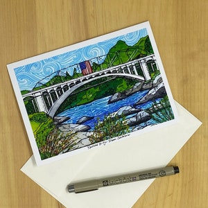 May include: A hand-drawn illustration of a bridge over a river with a small American flag on the bridge. The bridge is called "Rainbow Bridge - Placerville, California".