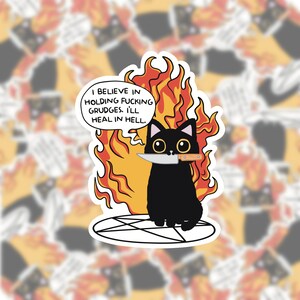May include: A sticker of a black cat with a knife, set against flames. The cat sits on a pentagram, with a speech bubble saying, "I believe in holding f*cking grudges. I'll heal in hell."
