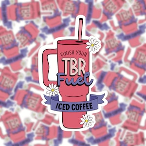 May include: Pink and white sticker with a cartoon illustration of a pink iced coffee cup with a straw and the text "Finish Your TBR Fuel Iced Coffee".