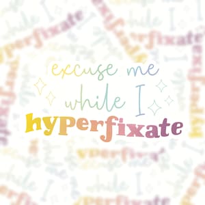 May include: A sticker with a rainbow gradient design that says "excuse me while I hyperfixate" with two small stars on either side of the text.