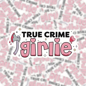 May include: A white sticker with the text "TRUE CRIME girlie" in pink letters. The sticker features a pink heart, a dripping blood heart, and a pink axe with a red handle and dripping blood.