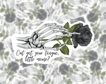 May include: A skeletal hand holding a black rose with green leaves. The text "Cat got your tongue, little mouse?" is below the hand and rose.