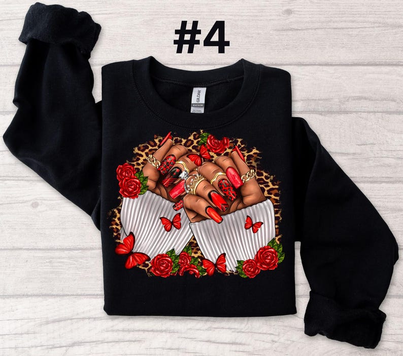 May include: Black sweatshirt with a graphic print of two hands with red nail polish and rings, holding red roses and butterflies on a leopard print background. The text "#4" is printed on the top of the sweatshirt.