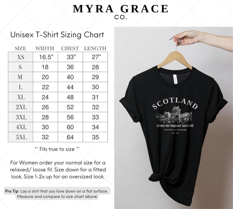 May include: Black unisex t-shirt with rolled-up sleeves, featuring the word "SCOTLAND" above a graphic of a castle and the text "nemo me impune lacessit" and "UNITED KINGDOM EST. 1543". A sizing chart is also visible.