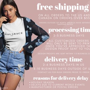 May include: A woman wearing a white t-shirt with the text "MYRA GRACE CO." and denim shorts. She is also wearing a sheer black kimono with blue floral patterns. The background is a light pink color with text about shipping and processing times.