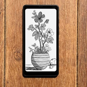May include: A black smartphone displays a black and white sketch of a potted plant with flowers and leaves. The plant is in a round, striped pot. The phone rests on a wooden surface.