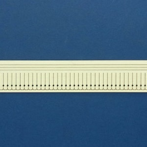 May include: A white sheet of paper with the text "M 70-45c" printed in the top left corner. The paper has a series of black dots and thin lines printed on it.