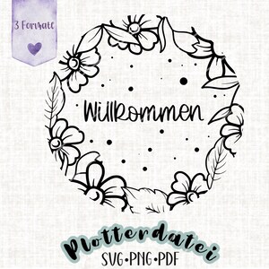 May include: Black and white illustration of a floral wreath with the word "Willkommen" in the center. The wreath is made of leaves and flowers.