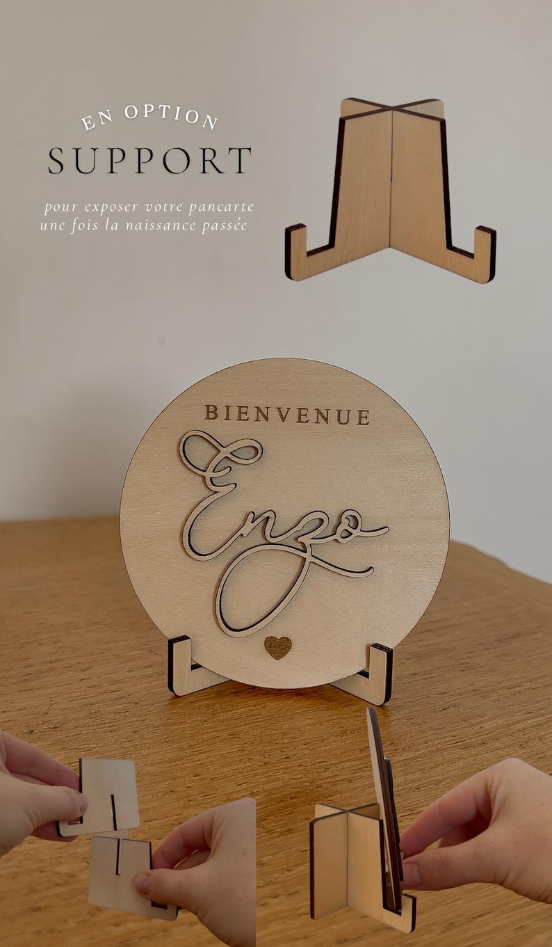 May include: Wooden welcome sign with the name "Enzo" in cursive script, a heart, and the word "Bienvenue". The sign is displayed on a wooden stand. The image also shows a separate stand.