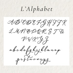 May include: A white background displays the uppercase and lowercase letters of the alphabet in a cursive font. The title "L'Alphabet" is written above the letters in a similar style.