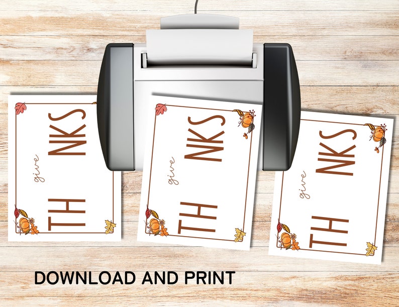 May include: Three printable cards with a white background and a brown border. The cards have an autumnal theme with orange pumpkins, brown leaves, and the text "give THANKS" in brown lettering.