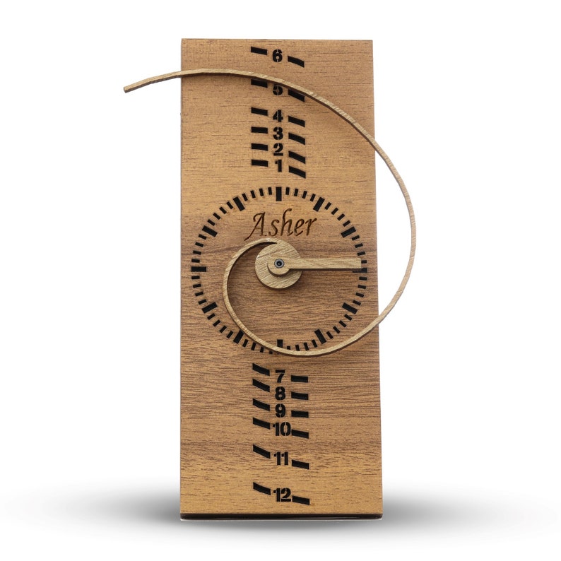 May include: Wooden growth chart with a spiral design and a clock face that says "Asher". The chart has numbers 1 through 12 on it.