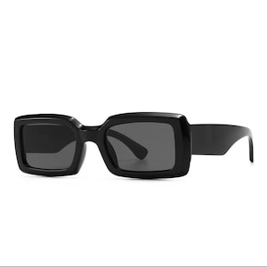 May include: Black rectangular sunglasses with a thick frame.