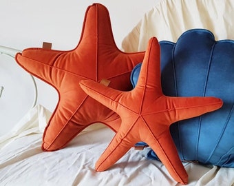 Set of 2 decorative velvet orange starfish cushions, ocean pillows for couch or on a bed in a bedroom, beach coastal decor in a living room