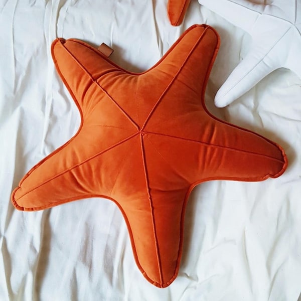 Decorative velvet orange starfish cushion, sea star shaped pillow in the ocean baby room, seaside home decor gift idea for the beach house