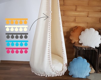 Hanging egg chair with pom poms, baby swing for kids room, safe and comortable boho hammock in the bedroom, cozy reading nook decor idea