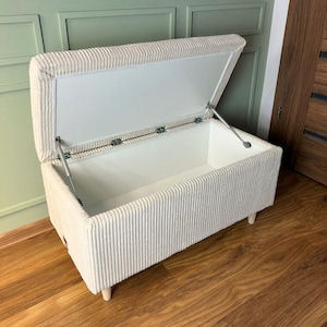 ivory lobby bench with a storage box in the vintage style made of cord fabric for the living room in the german style